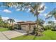 Charming single-story home with a well-manicured lawn, lush landscaping, and a two-car garage at 20632 Broadwater Dr, Land O Lakes, FL 34638