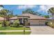 Well-maintained home with a three-car garage, lush lawn and landscaping at 20632 Broadwater Dr, Land O Lakes, FL 34638