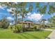 Beautifully landscaped home featuring lush green lawn and vibrant tropical plants at 20632 Broadwater Dr, Land O Lakes, FL 34638