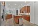 Open kitchen with stainless steel appliances, central island, and seamlessly integrated breakfast bar area at 20632 Broadwater Dr, Land O Lakes, FL 34638