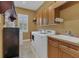 This laundry room features a washing machine, dryer, sink, and cabinetry at 20632 Broadwater Dr, Land O Lakes, FL 34638