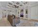 Open-concept living room with coffered ceilings, elegant columns, built-in shelves, and a neutral color palette at 20632 Broadwater Dr, Land O Lakes, FL 34638
