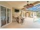 Screened outdoor area with bar, seating, and television provides a perfect space for entertaining by the pool at 20632 Broadwater Dr, Land O Lakes, FL 34638