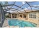 Stunning screened in pool with ample seating, a covered bar, and an expansive outdoor entertainment area at 20632 Broadwater Dr, Land O Lakes, FL 34638