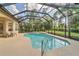 Beautiful, screened-in pool and spa with lush greenery provide a private and serene outdoor living space at 20632 Broadwater Dr, Land O Lakes, FL 34638