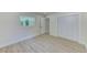 Spacious room with light wood-look floors, closet, and window at 2220 Calexico S Way, St Petersburg, FL 33712