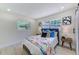 Comfortable bedroom featuring light-colored walls, wood-look flooring, and two windows at 2220 Calexico S Way, St Petersburg, FL 33712