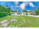 Beautiful single-story home with a well-maintained lawn, complimented by a light-green garage and front door at 2220 Calexico S Way, St Petersburg, FL 33712