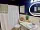 Well-maintained bathroom with blue accent wall, shower-tub combination, and updated fixtures at 2254 Norwegian Dr # 46, Clearwater, FL 33763