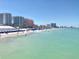 Scenic beach view with turquoise water and residential buildings in the background on a bright day at 2254 Norwegian Dr # 46, Clearwater, FL 33763