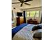 Comfortable bedroom with large window, desk, dresser, television, and neutral color palette at 2254 Norwegian Dr # 46, Clearwater, FL 33763