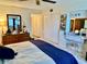 Bright bedroom featuring a dresser, two closets, vanity, and ample storage space at 2254 Norwegian Dr # 46, Clearwater, FL 33763