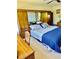 Cozy bedroom featuring a comfortable bed with a blue patterned quilt, wooden furniture, and ample closet space at 2254 Norwegian Dr # 46, Clearwater, FL 33763
