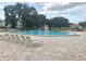 Large community pool surrounded by brick pavers and lounge chairs under a partly cloudy sky at 2254 Norwegian Dr # 46, Clearwater, FL 33763