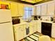 Functional kitchen with white cabinets, black appliances, and laminate countertops at 2254 Norwegian Dr # 46, Clearwater, FL 33763