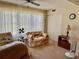 Cozy sitting area with a comfortable sofa and large bright windows with ceiling fan at 2254 Norwegian Dr # 46, Clearwater, FL 33763