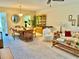Bright living room with a dining area and a view into the kitchen with comfortable furniture at 2254 Norwegian Dr # 46, Clearwater, FL 33763