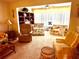 Inviting living room with a variety of seating options, large windows, and a bookshelf for storage and decor at 2254 Norwegian Dr # 46, Clearwater, FL 33763