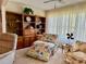 Comfortable seating area with built-in bookshelves and a large window with a ceiling fan at 2254 Norwegian Dr # 46, Clearwater, FL 33763