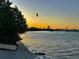 Waterfront view featuring a bird flying across the orange sunset and boats docked nearby at 2254 Norwegian Dr # 46, Clearwater, FL 33763