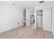 Neutral bedroom with built-in shelving, closet with sliding doors, and view to open floorplan at 2322 21St S St, St Petersburg, FL 33712