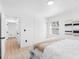 Bright bedroom showcasing a white bed, natural light, closet, and adjacent bathroom and closet at 2322 21St S St, St Petersburg, FL 33712
