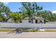 Charming single-story home surrounded by a white fence and lush greenery, creating a private oasis at 2322 21St S St, St Petersburg, FL 33712