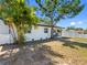 Lovely single-story home featuring a well-manicured lawn, palm trees, and a classic white picket fence at 2322 21St S St, St Petersburg, FL 33712