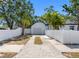 A long drive leads to a two-car detached garage behind a white privacy fence at 2322 21St S St, St Petersburg, FL 33712