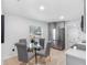 Bright eat-in kitchen features gray cabinets, stainless appliances, and a glass dining table at 2322 21St S St, St Petersburg, FL 33712