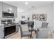 This kitchen offers stainless steel appliances, gray cabinetry, and a glass table with seating at 2322 21St S St, St Petersburg, FL 33712