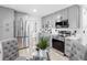 Modern kitchen featuring stainless steel appliances, gray cabinets and countertops, plus wood-look flooring at 2322 21St S St, St Petersburg, FL 33712