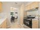 Well-lit kitchen with modern appliances and a view to a dining area at 2410 E Bougainvillea Ave, Tampa, FL 33612