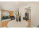 Inviting open-concept living area with wood paneling, stylish decor, and a glimpse into the kitchen at 2410 E Bougainvillea Ave, Tampa, FL 33612