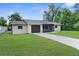 Inviting one-story home with attached garage, screened porch and lush front lawn at 2444 Magellan Ave, Spring Hill, FL 34608