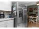 Modern kitchen features stainless steel refrigerator and eat-in dining area with bright natural light at 2444 Magellan Ave, Spring Hill, FL 34608