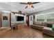 Bright and inviting living room with a ceiling fan, a television, a sofa, and lots of space at 2444 Magellan Ave, Spring Hill, FL 34608