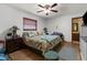 Relaxing main bedroom with ceiling fan, ensuite bathroom, and large window offering natural light at 2444 Magellan Ave, Spring Hill, FL 34608