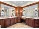 Bathroom with double vanity, granite counters, custom wood trim, and marble floors at 2513 Buckhorn Run Dr, Valrico, FL 33596