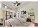 Bright bedroom boasts vaulted ceiling, view of pool, arched windows and modern decor at 2513 Buckhorn Run Dr, Valrico, FL 33596