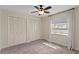 Bright bedroom features carpet, a ceiling fan, natural light, and double closets at 2513 Buckhorn Run Dr, Valrico, FL 33596