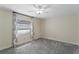 Cozy bedroom with a ceiling fan, large window, and neutral-toned walls at 2513 Buckhorn Run Dr, Valrico, FL 33596