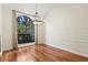 Bright dining room with hardwood floors, chandelier, and large window at 2513 Buckhorn Run Dr, Valrico, FL 33596
