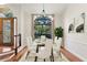 Bright dining room with a glass table set, chandelier, and large window overlooking the lush landscaping at 2513 Buckhorn Run Dr, Valrico, FL 33596