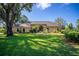 Expansive single-story home with well-manicured lawn, mature trees, and a circular driveway at 2513 Buckhorn Run Dr, Valrico, FL 33596