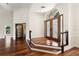 Grand foyer featuring beautiful hardwood floors, elegant staircase, and double-door entrance at 2513 Buckhorn Run Dr, Valrico, FL 33596