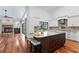 Kitchen featuring custom cabinets, stainless steel appliances, a large center island, and hardwood flooring at 2513 Buckhorn Run Dr, Valrico, FL 33596