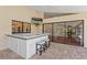 Outdoor kitchen featuring granite counters, bar seating, and a view of the home's interior at 2513 Buckhorn Run Dr, Valrico, FL 33596