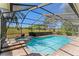 Relaxing pool features a screen enclosure, beautiful brick pavers, and a lovely spa at 2513 Buckhorn Run Dr, Valrico, FL 33596