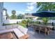 Beautiful backyard showcasing a spacious deck with comfortable seating, an outdoor dining area, and a well-manicured lawn at 2707 W Fig St, Tampa, FL 33609